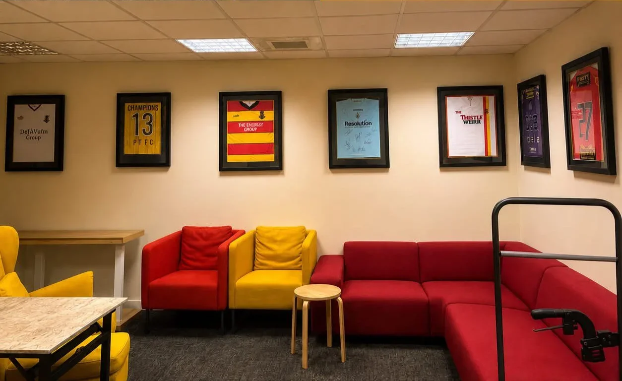 The PTDSA room at Firhill - comfy seating, accessible features with framed Thistle shirts on the wall.